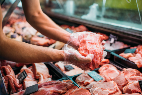 shop assistant with raw meat