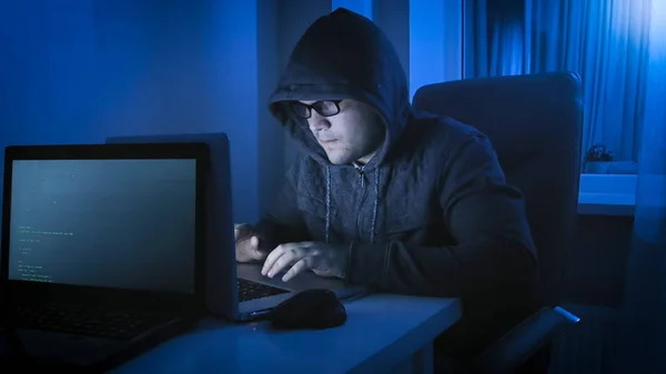 hacker typing on laptop