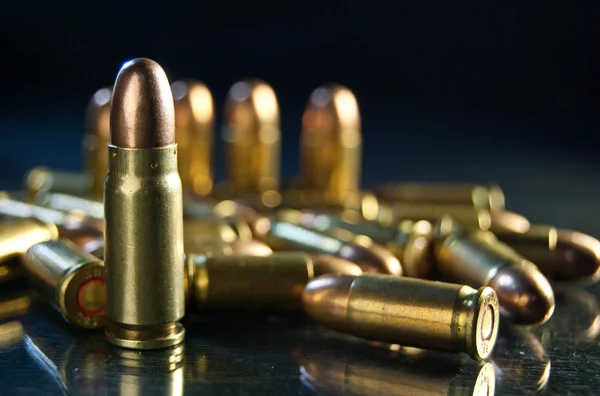 depositphotos_115752398-stock-photo-bullet-dark-background