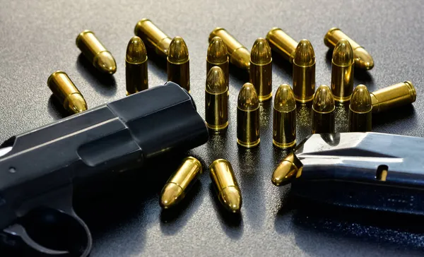depositphotos_523904254-stock-photo-photo-black-pistol-bullet