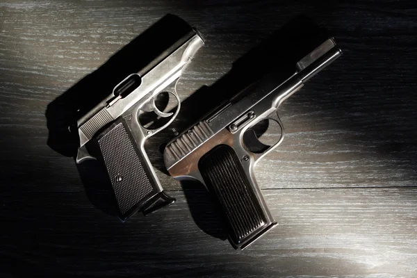 depositphotos_88690126-stock-photo-two-pistols-on-dark (1)